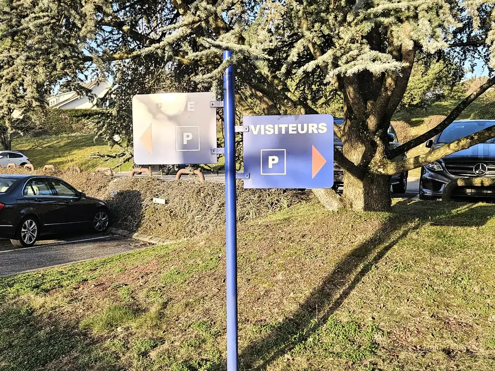 Panneau bleu indiquant le parking des visiteurs