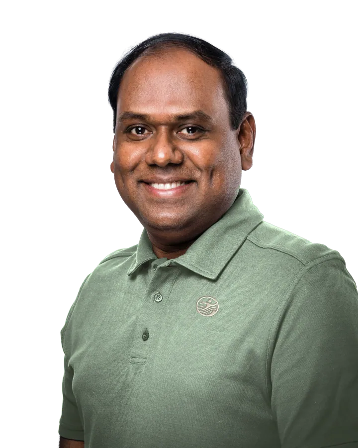 Santhanamoorthy Krishnasamy, physiotherapist, smiling, in a PhysioWay polo shirt